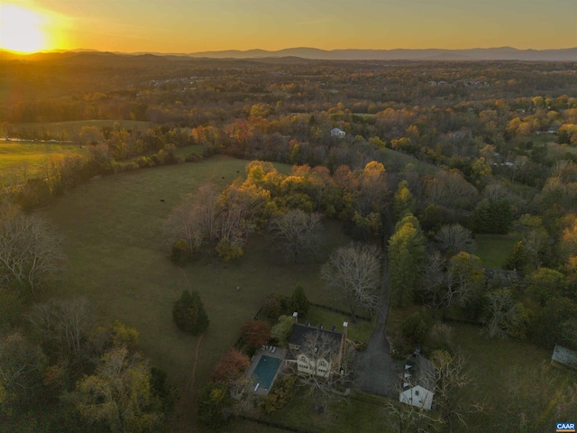 aerial view at dusk featuring a mountain view