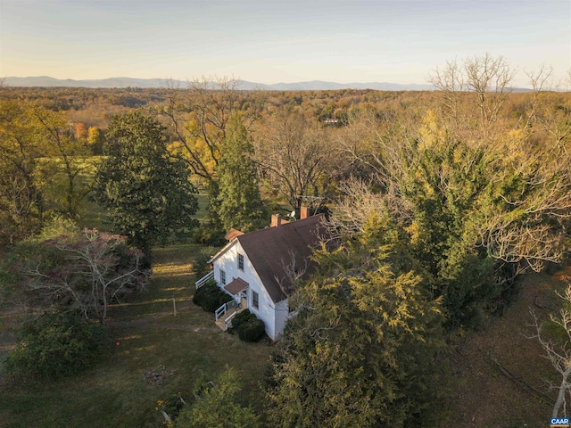 birds eye view of property with a forest view and a mountain view