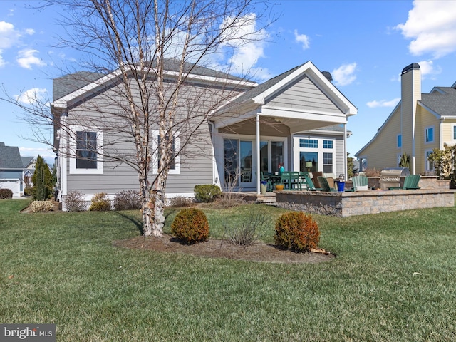 rear view of house with a lawn