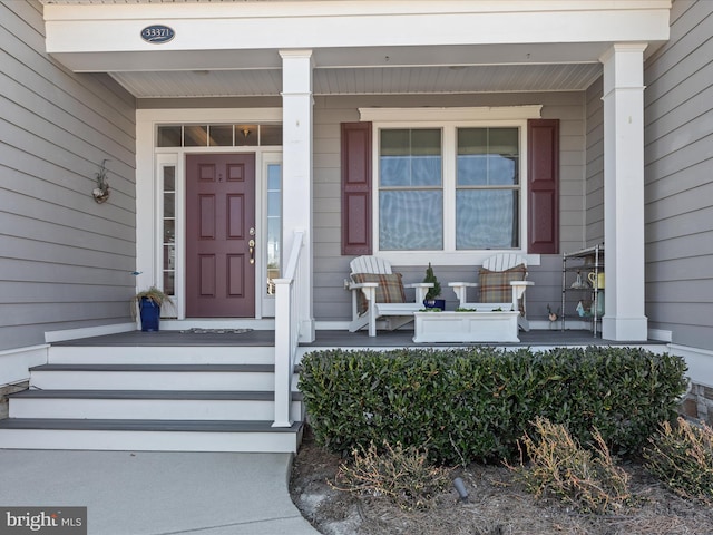 view of exterior entry featuring a porch