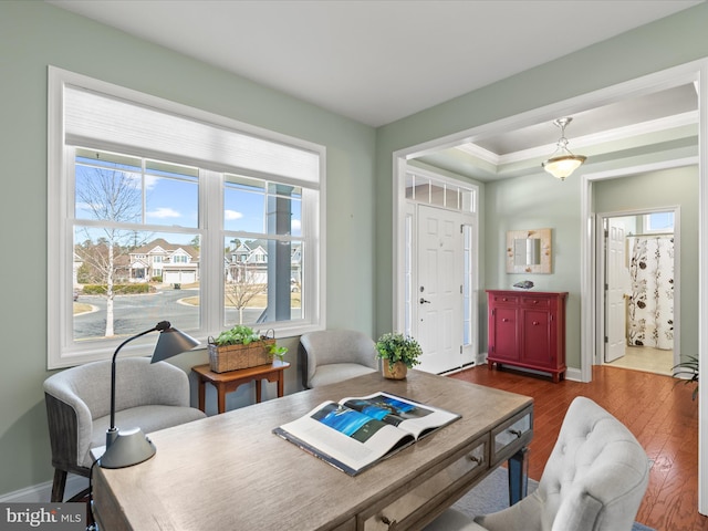 interior space featuring dark wood-style floors, ornamental molding, and baseboards