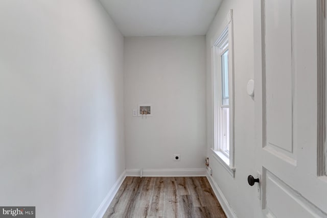 laundry room featuring laundry area, baseboards, light wood-type flooring, washer hookup, and electric dryer hookup