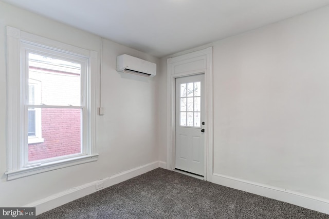 doorway featuring a wall unit AC, dark carpet, and baseboards