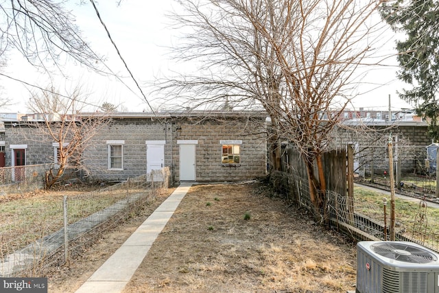 view of front of property with fence and cooling unit