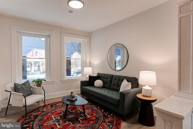 living area featuring baseboards and wood finished floors