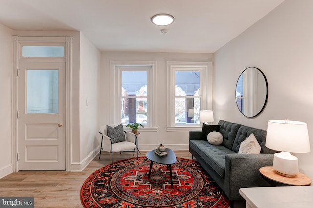 living area featuring light wood-type flooring and baseboards