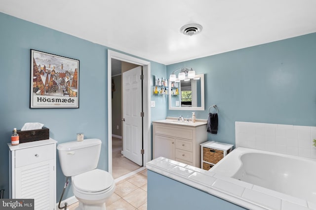 bathroom with tile patterned flooring, visible vents, toilet, a garden tub, and vanity