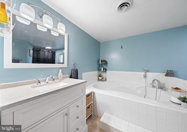 full bath featuring tile patterned floors, visible vents, a bath, and vanity