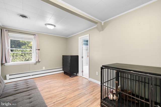 living area with wood finished floors, baseboards, visible vents, ornamental molding, and baseboard heating