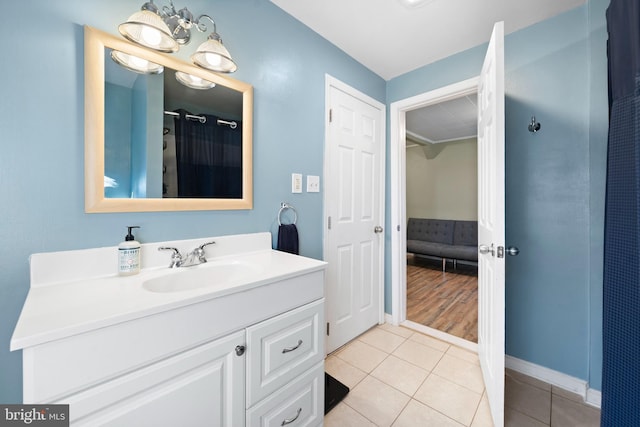 full bathroom with tile patterned flooring, a shower with shower curtain, vanity, and baseboards