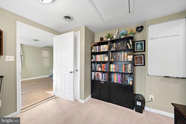 interior space with visible vents, baseboards, carpet, and attic access