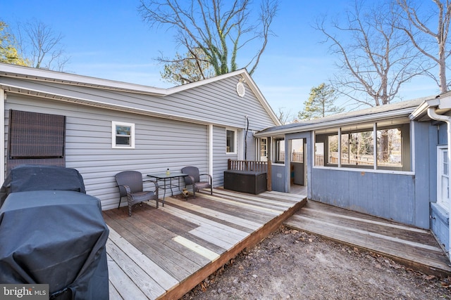 wooden deck featuring a grill