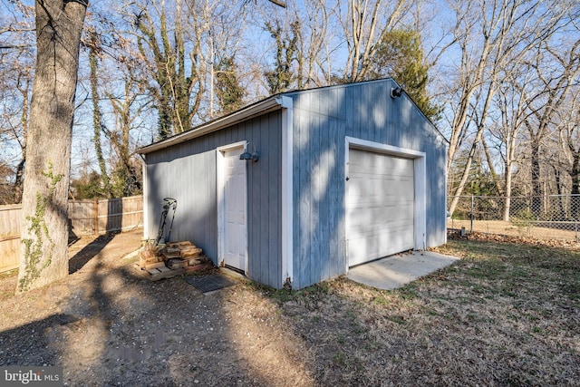 detached garage featuring fence