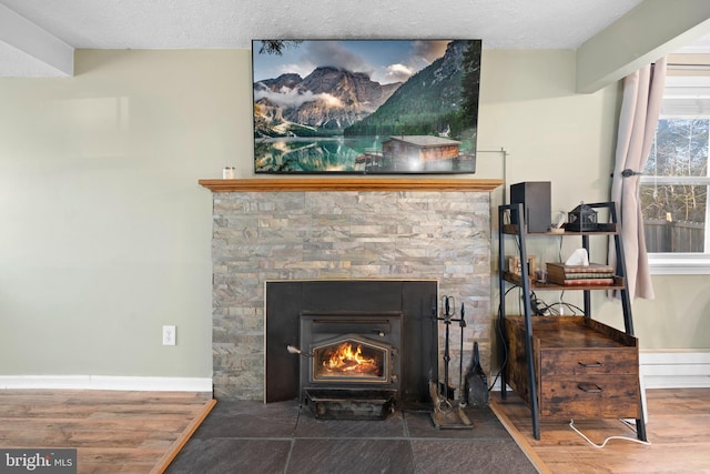 room details with wood finished floors, baseboards, and a textured ceiling