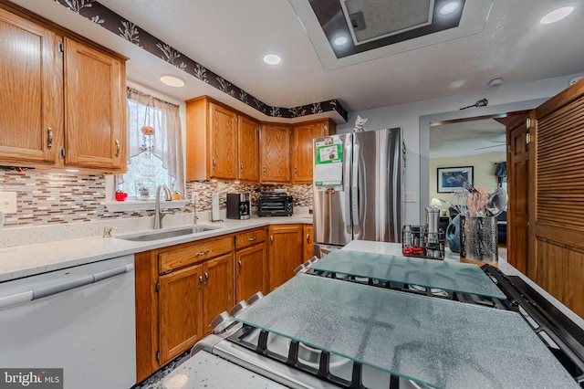 701 Paris Kirby Rd, Milford, DE 19963 - kitchen with dishwashing machine, a sink, freestanding refrigerator, decorative backsplash, and light countertops