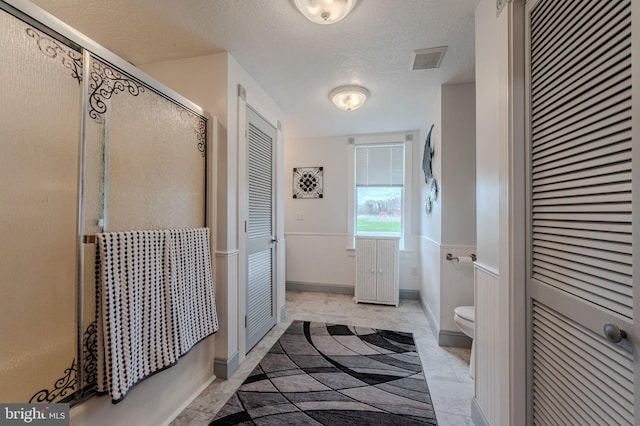 701 Paris Kirby Rd, Milford, DE 19963 - full bathroom featuring a closet, a stall shower, toilet, and a textured ceiling