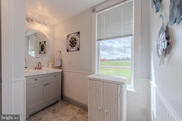701 Paris Kirby Rd, Milford, DE 19963 - bathroom with wainscoting, vanity, and a decorative wall