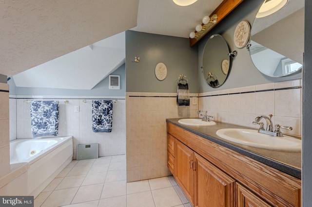 701 Paris Kirby Rd, Milford, DE 19963 - bathroom featuring tile walls, tile patterned flooring, a bath, double vanity, and a wainscoted wall