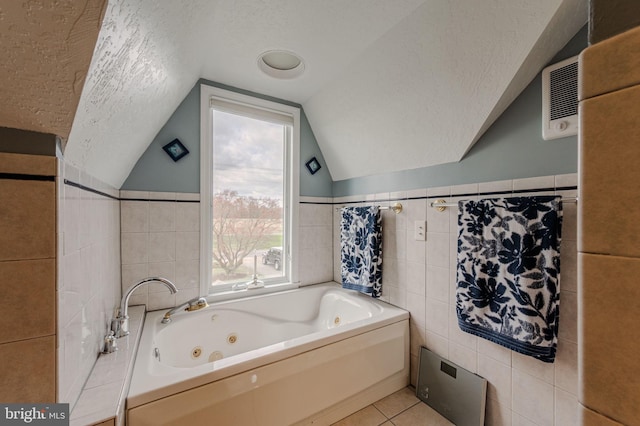 701 Paris Kirby Rd, Milford, DE 19963 - full bathroom featuring tile walls, a textured ceiling, plenty of natural light, a jetted tub, and tile patterned floors