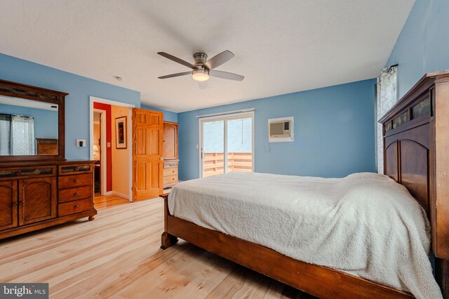 701 Paris Kirby Rd, Milford, DE 19963 - bedroom featuring light wood-style flooring, a wall mounted AC, access to exterior, and a ceiling fan
