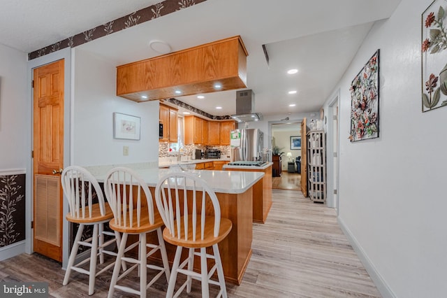 701 Paris Kirby Rd, Milford, DE 19963 - kitchen with a peninsula, stainless steel fridge with ice dispenser, light wood finished floors, a sink, and light countertops