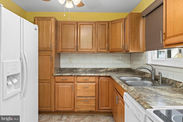 kitchen featuring white appliances, backsplash, brown cabinetry, and a sink