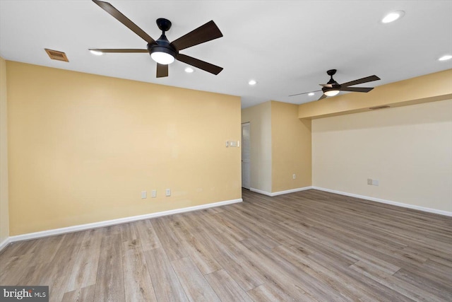 spare room with visible vents, baseboards, wood finished floors, and recessed lighting