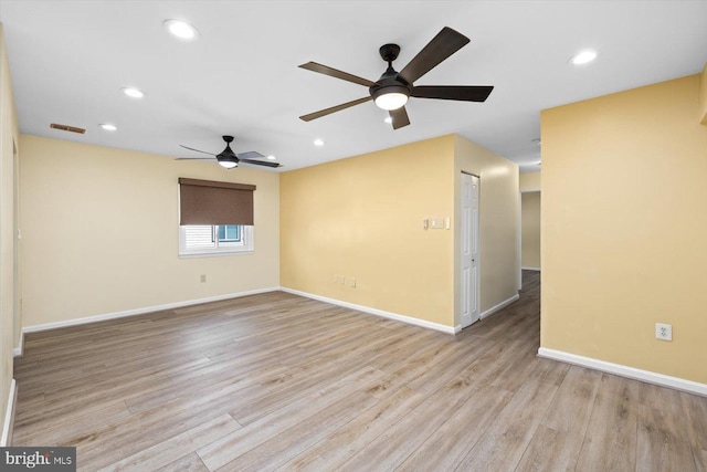 empty room with recessed lighting, visible vents, baseboards, and wood finished floors