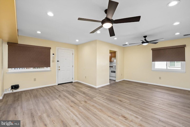 unfurnished living room with light wood-style floors, recessed lighting, visible vents, and baseboards