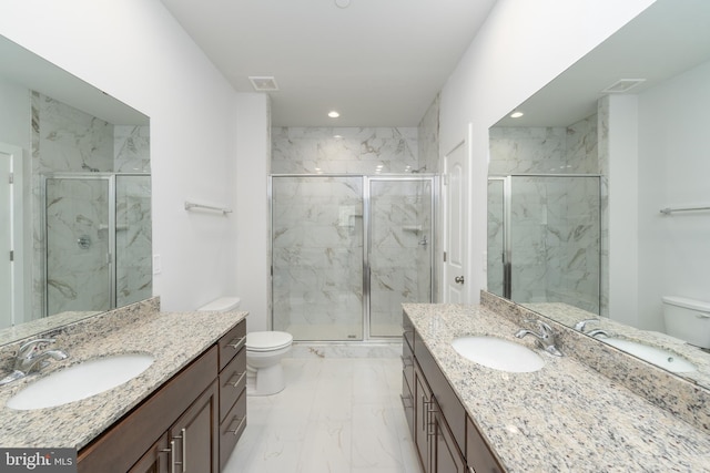 full bath with a marble finish shower, a sink, and toilet