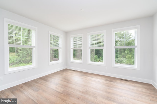 unfurnished sunroom with visible vents