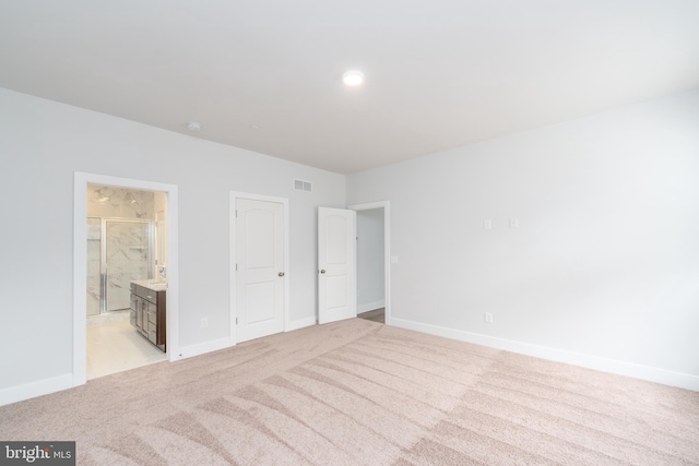 unfurnished bedroom with light carpet and baseboards