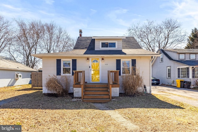 view of front of home featuring roof with shingles