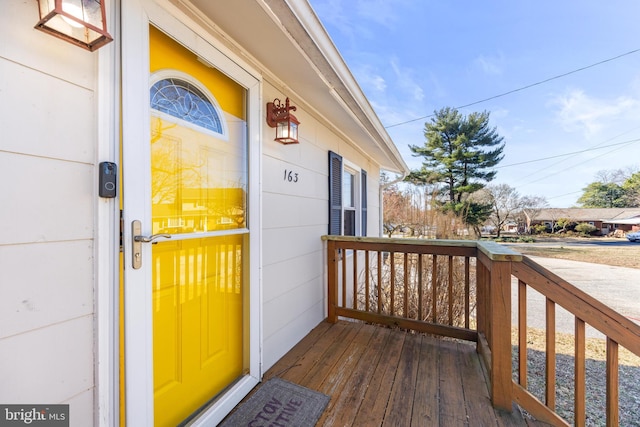 view of exterior entry featuring covered porch