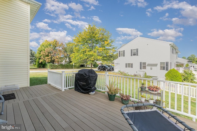 deck featuring a lawn and a grill