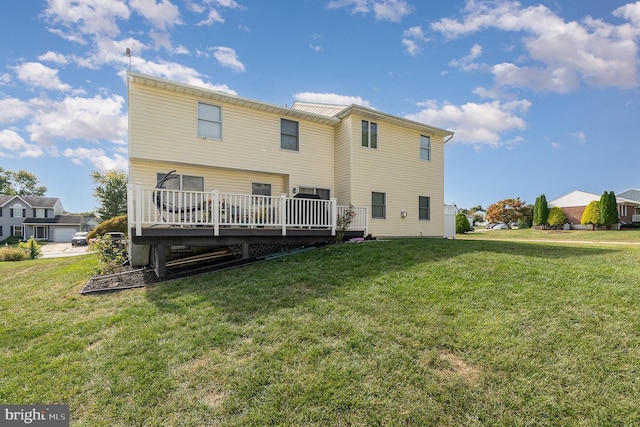 rear view of property with a lawn and a wooden deck