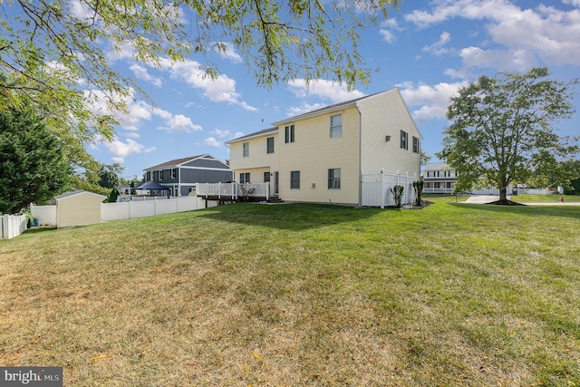 back of property with a yard and fence