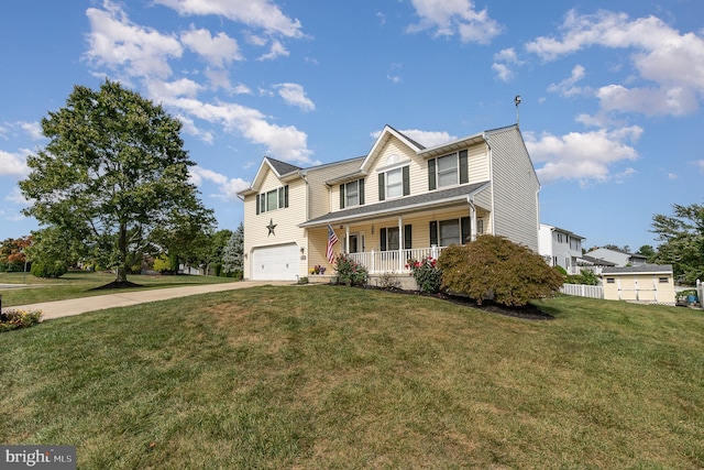 traditional-style home with a garage, driveway, a porch, and a front yard