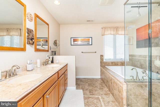 bathroom with a healthy amount of sunlight, visible vents, and a sink