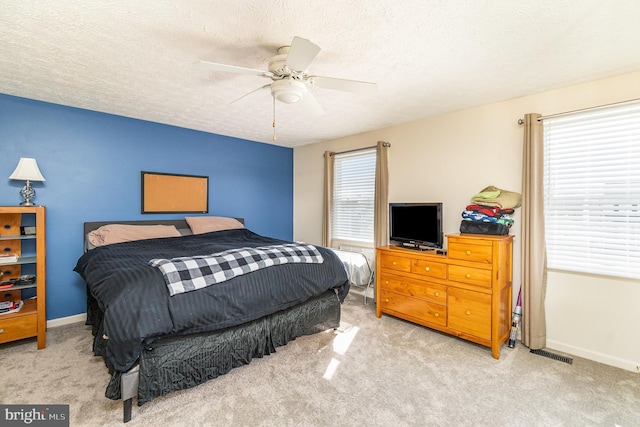 bedroom featuring carpet floors, multiple windows, and visible vents