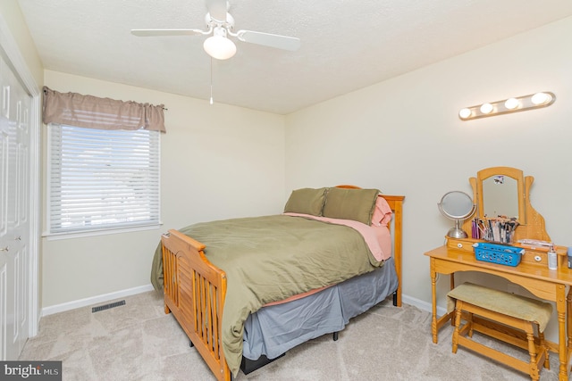 bedroom featuring carpet floors, a closet, visible vents, ceiling fan, and baseboards