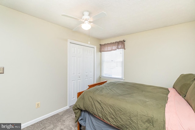 carpeted bedroom with a closet, a ceiling fan, and baseboards