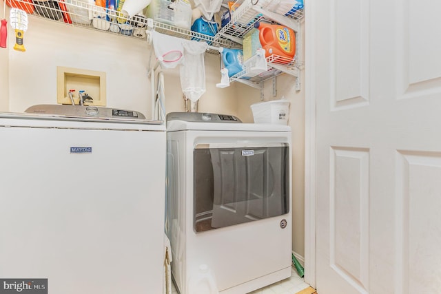 clothes washing area with laundry area and washer and dryer