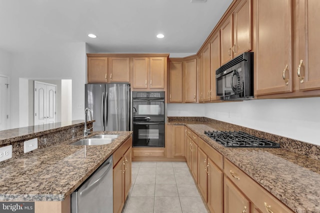 kitchen with stone counters, recessed lighting, light tile patterned flooring, a sink, and black appliances