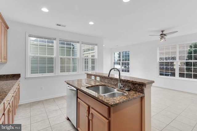 kitchen with visible vents, a sink, a kitchen island with sink, stainless steel dishwasher, and light tile patterned flooring