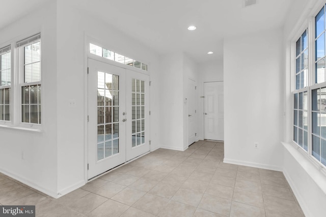 interior space with light tile patterned flooring, recessed lighting, baseboards, and french doors