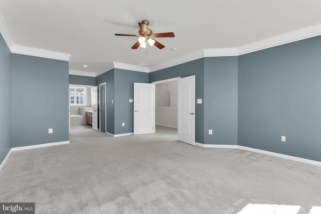 unfurnished bedroom featuring light carpet, crown molding, and baseboards