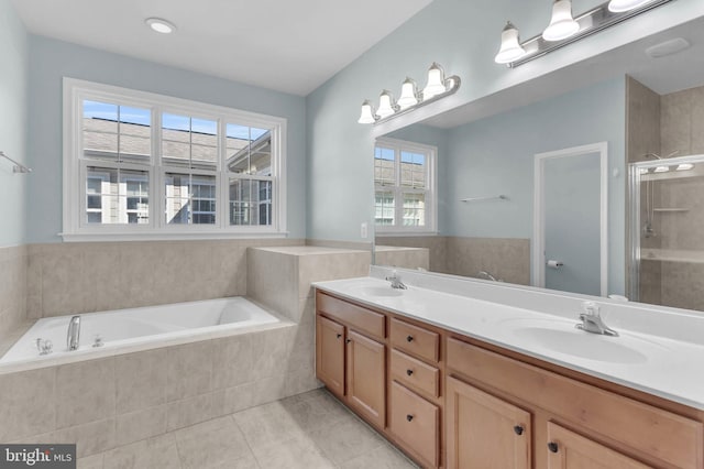 full bath with double vanity, a stall shower, a sink, and a bath