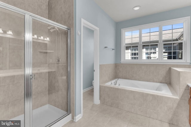 bathroom featuring toilet, a stall shower, tile patterned flooring, and a garden tub