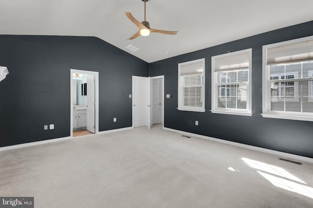 unfurnished bedroom with lofted ceiling, carpet floors, visible vents, and baseboards